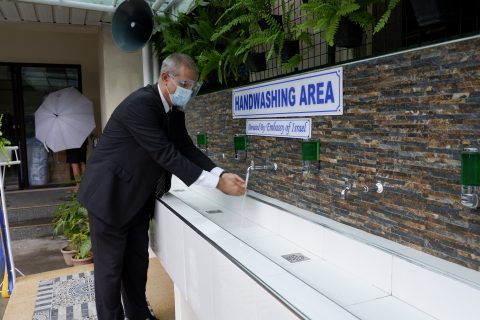 Ambassador-Harpaz-tries-the-handwashing-facility-donated-to-Makati-High-School